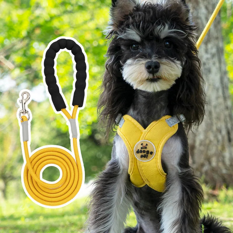 Blue polyester dog vest harness with an attached hand-held rope for walking.