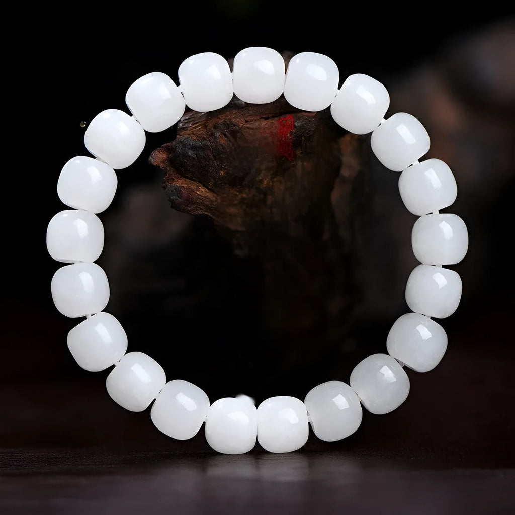 White Hetian jade barrel bead bracelet for men and women on a wrist, showing three bead size options.