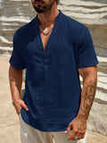 Men's solid colour stand collar short-sleeved casual shirt laid flat, showing slit detail and thin fabric.