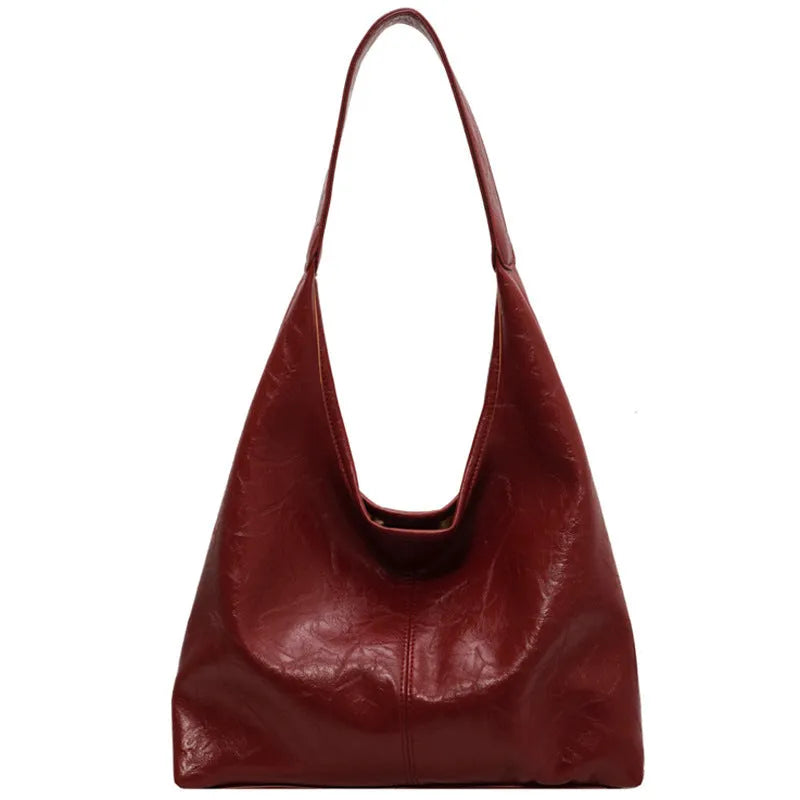 Soft leather shoulder bag in black with sandwich pocket design and shoulder strap
