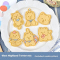 Three dimensional plastic biscuit mould showing puppy cartoon designs including birthday hats and swimming rings