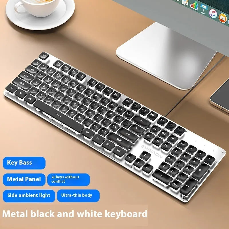 Wired computer keyboard with mute button and blue backlighting on a desk