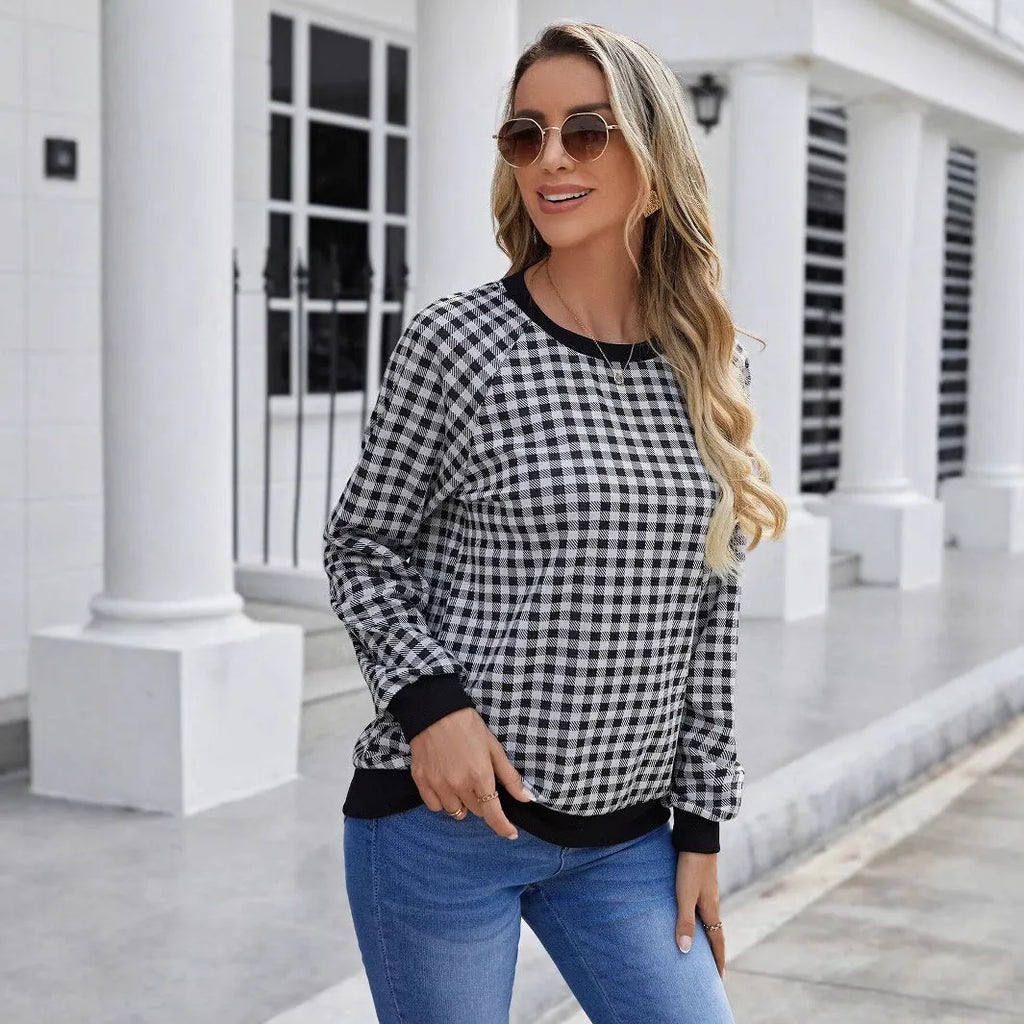 Black long sleeve pullover sweater with printed plaid and stripe pattern on a mannequin
