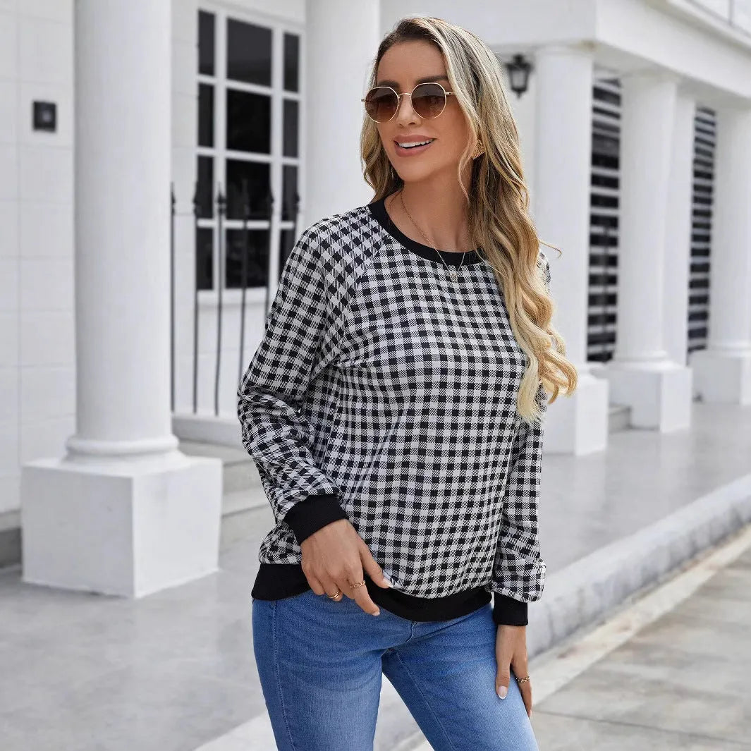 Black long sleeve pullover sweater with printed plaid and stripe pattern on a mannequin