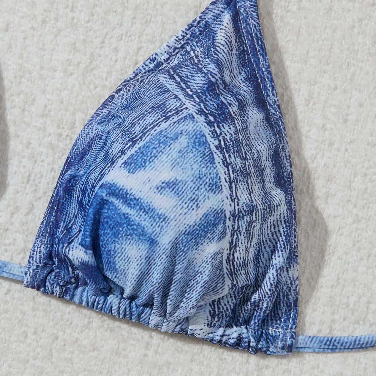 Women's denim blue printed bikini set with adjustable straps on mannequin