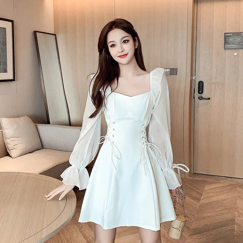 White chiffon patchwork dress with long sleeves and a floor-length skirt on a model, showcasing a slim fit silhouette.