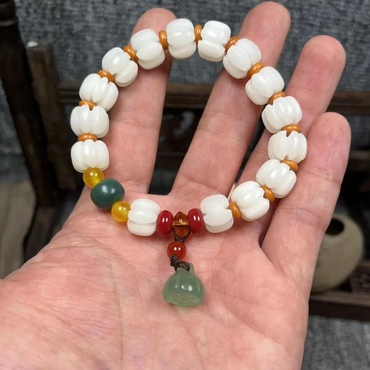 Carved pumpkin lotus bodhi root bracelet with white jade segments and golden silk jade treasures