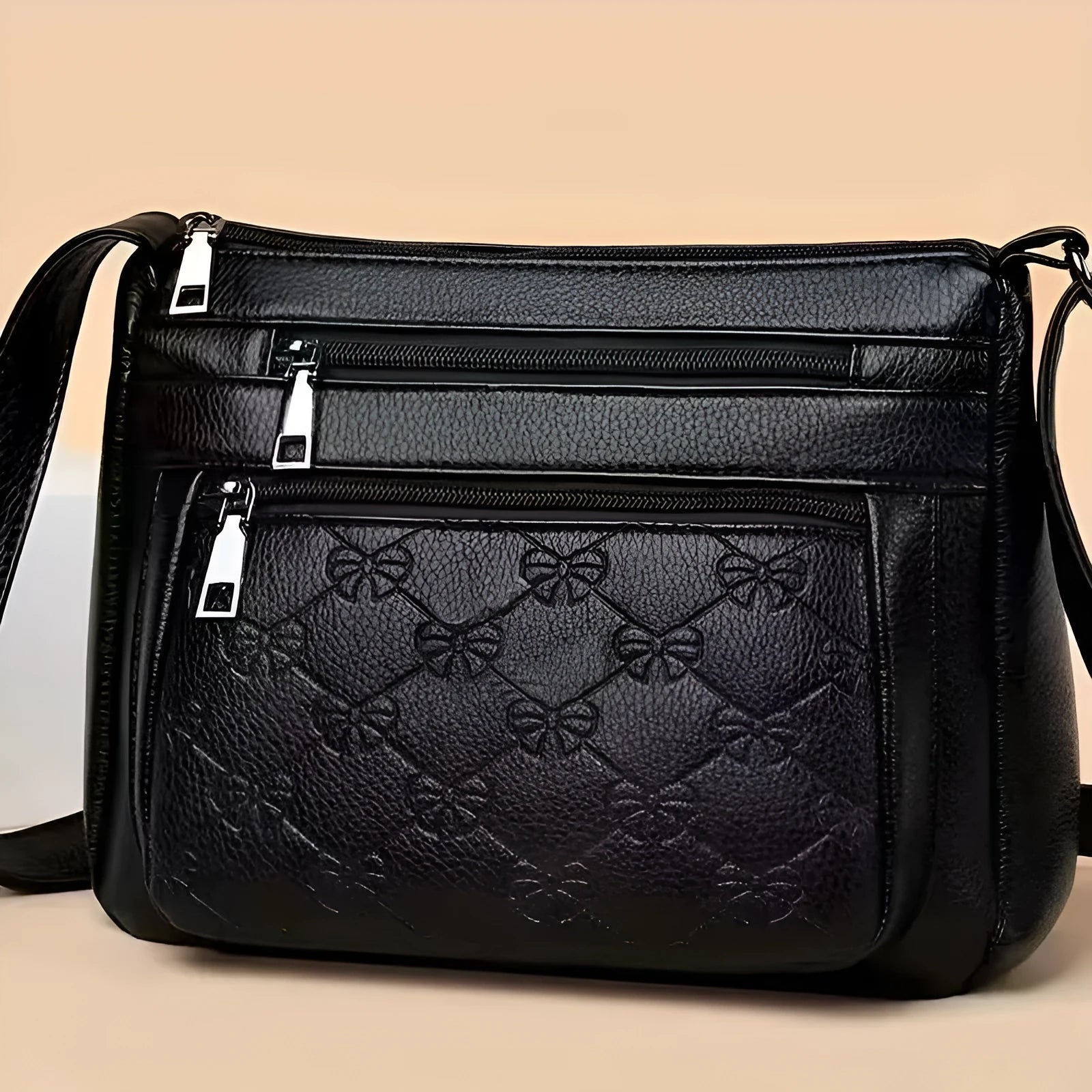 Women's black PU leather crossbody shoulder bag with embossed pattern and phone pocket