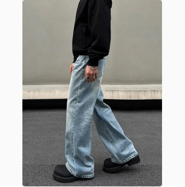 Men's blue straight leg jeans with whisker wash detailing and visible stitching on medium-high waist