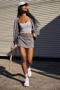 Women's blue hooded jacket and matching mini skirt street style outfit on a hanger.