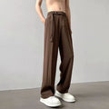 A pair of thin, black wide leg trousers with a straight cut and loose fit, laid flat.