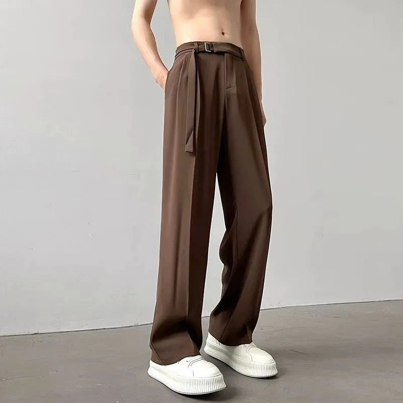 A pair of thin, black wide leg trousers with a straight cut and loose fit, laid flat.