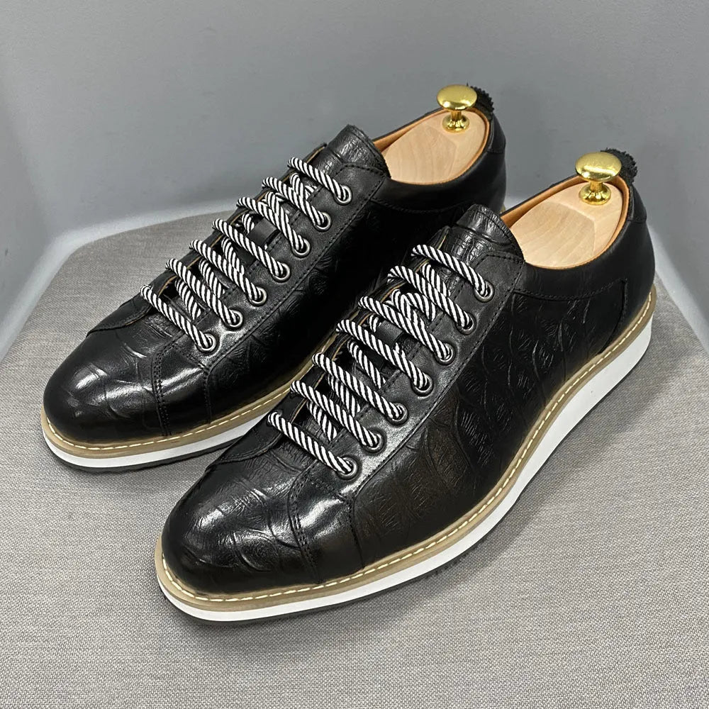 Men's low-top shoes with a handmade embossed pattern on the upper and front lace closure.