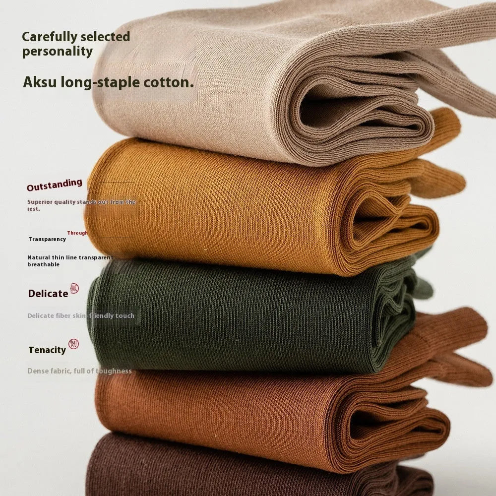 Men's solid colour pure cotton mid-calf business socks in beige, black, grey and blue shown folded.