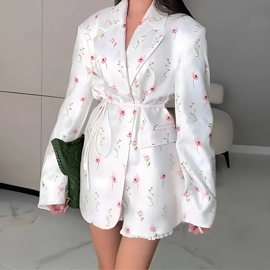 Women's white blazer with a lace-up fastening detail at the waist, shown on a hanger.