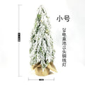 Small 24-inch white artificial Christmas tree with LED lights and snow-covered branches on a desktop.
