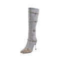 Grey women's knee-high boots with a thin high heel on a rubber sole.
