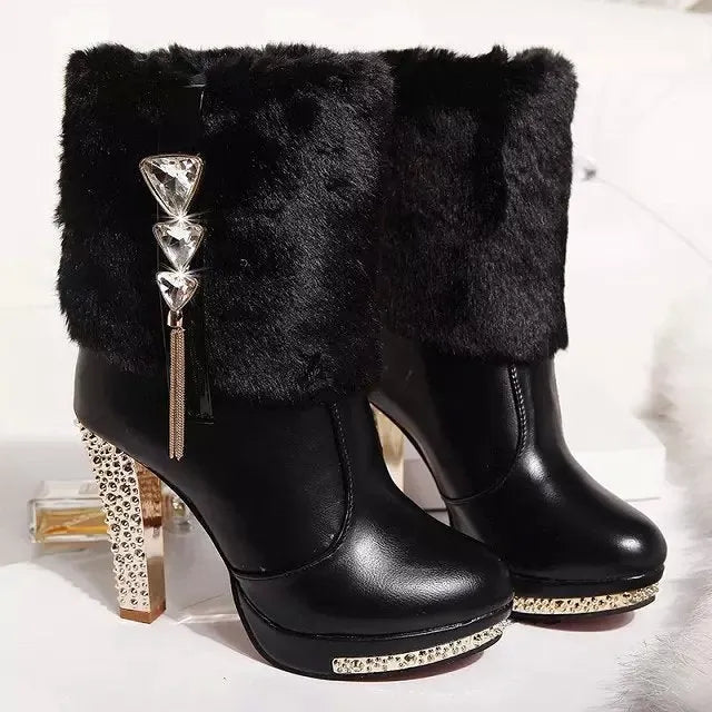 Women's black and white ankle boots with a chunky high heel on a solid colour background