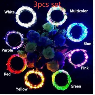 Silver wire LED string lights coiled around wine bottle with illuminated bulbs and bottle stopper fitting