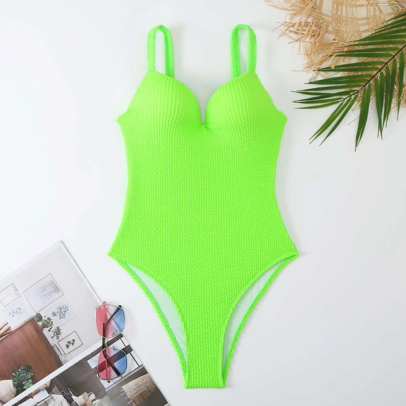 A women's sleeveless one-piece swimsuit on a hanger, shown in black, with other colour options available.