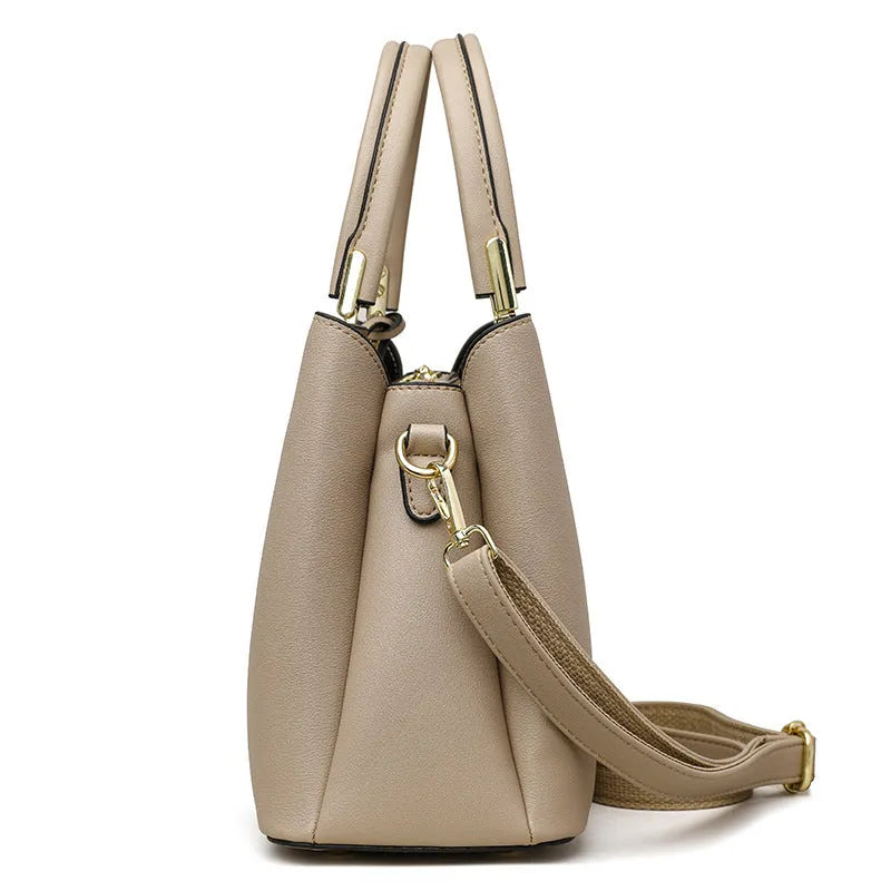 Women's black PU messenger bag with multi-layer design and visible sewing thread detail.