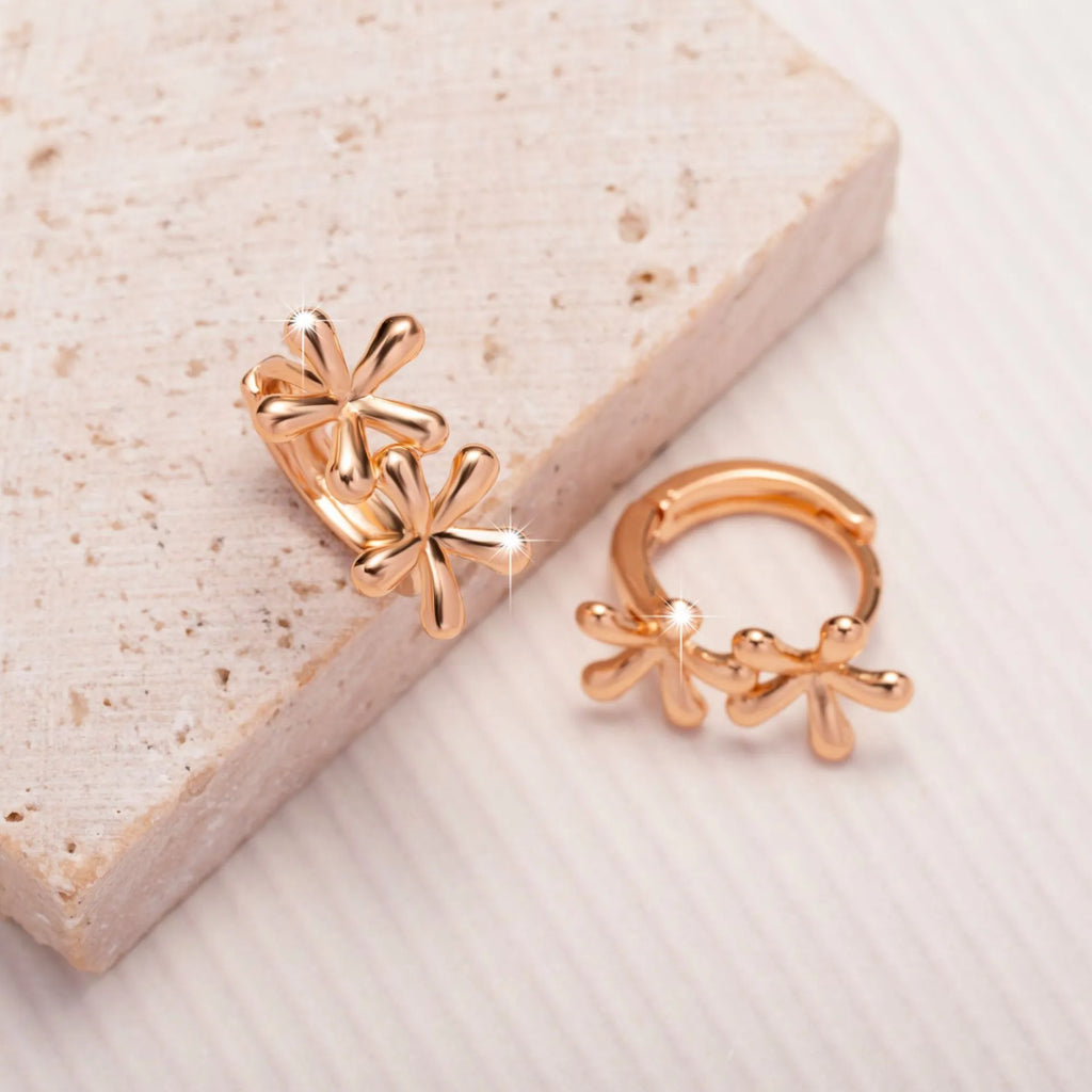 Circular rose gold earrings with a waterdrop flower design for women.