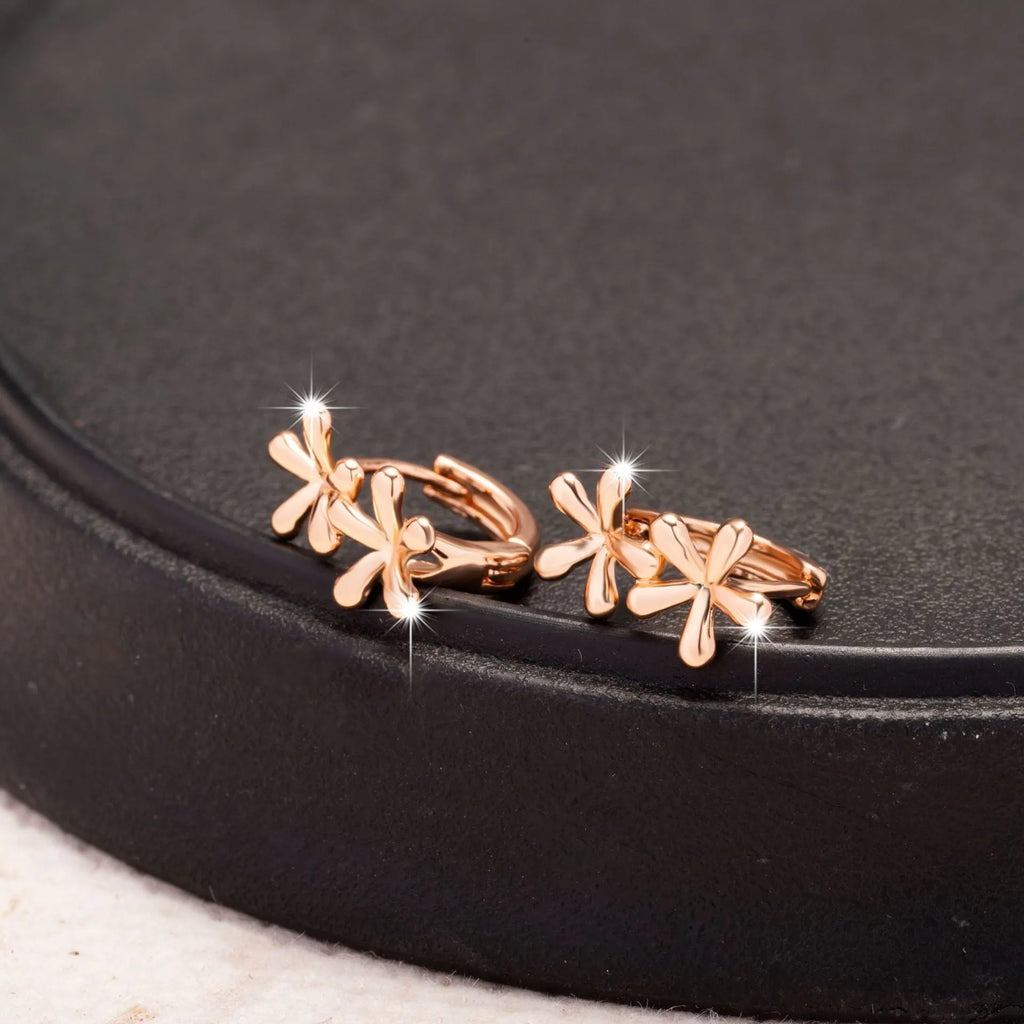 Circular rose gold earrings with a waterdrop flower design for women.