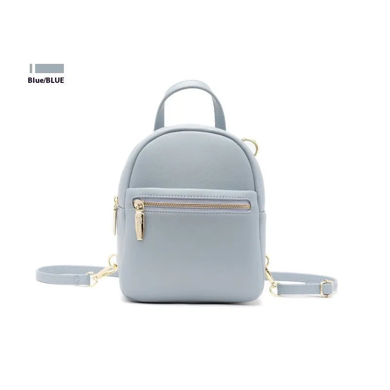 Soft black PU mini backpack with front pockets, shown open to reveal internal mobile phone sleeve and zipper compartment.