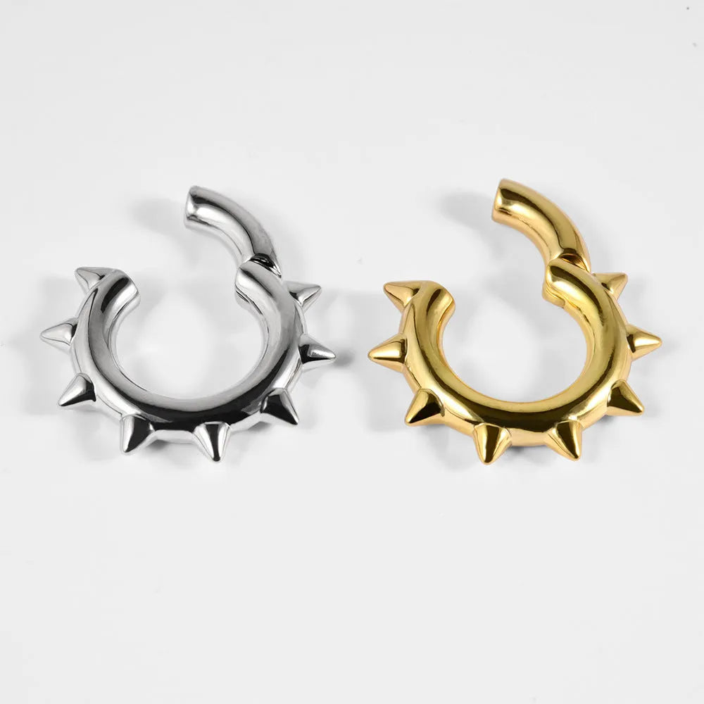 A pair of copper geometric cone and round shaped magnetic ear extenders on a white background.