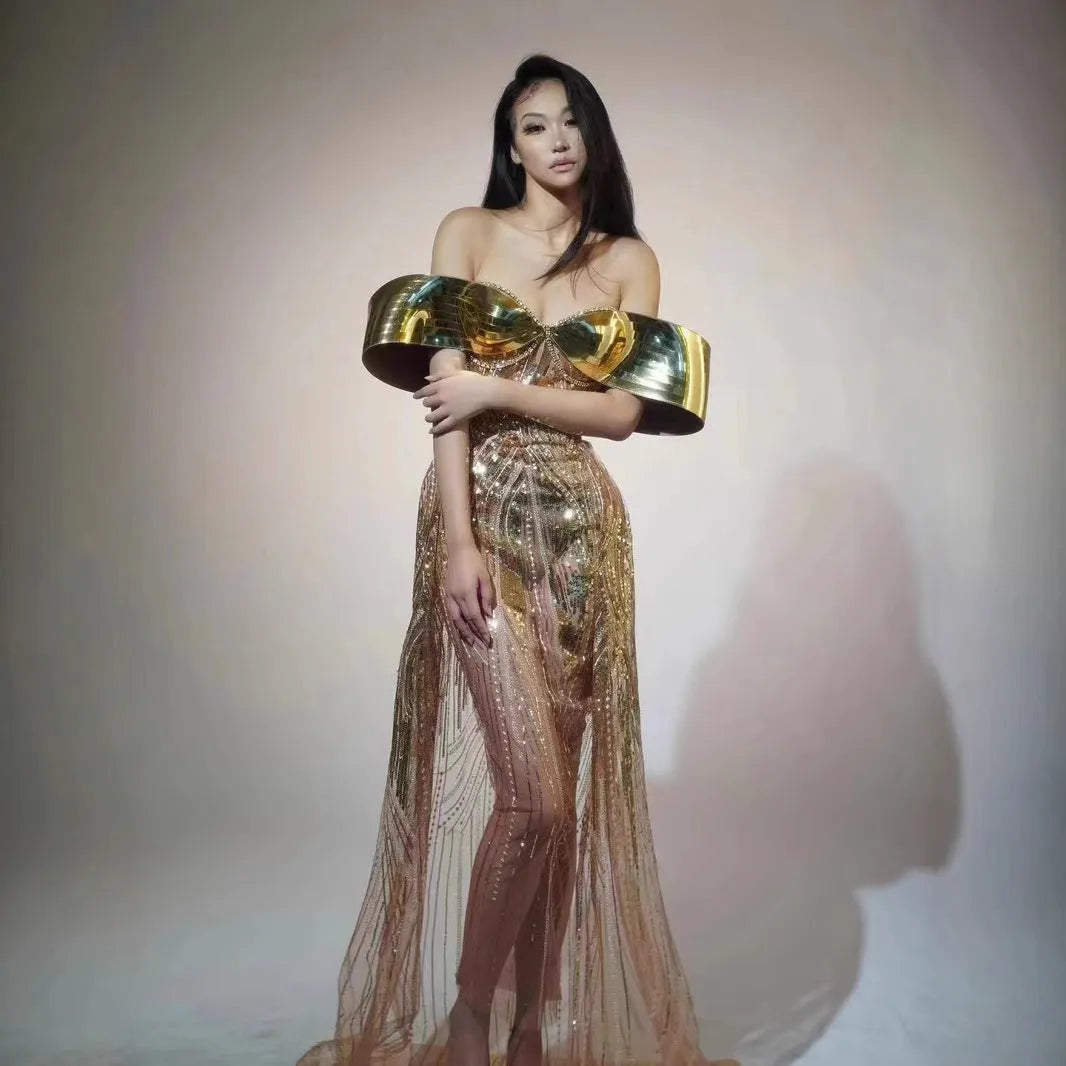 Gold sequined strapless long evening dress with a high split on the skirt, shown on a model.