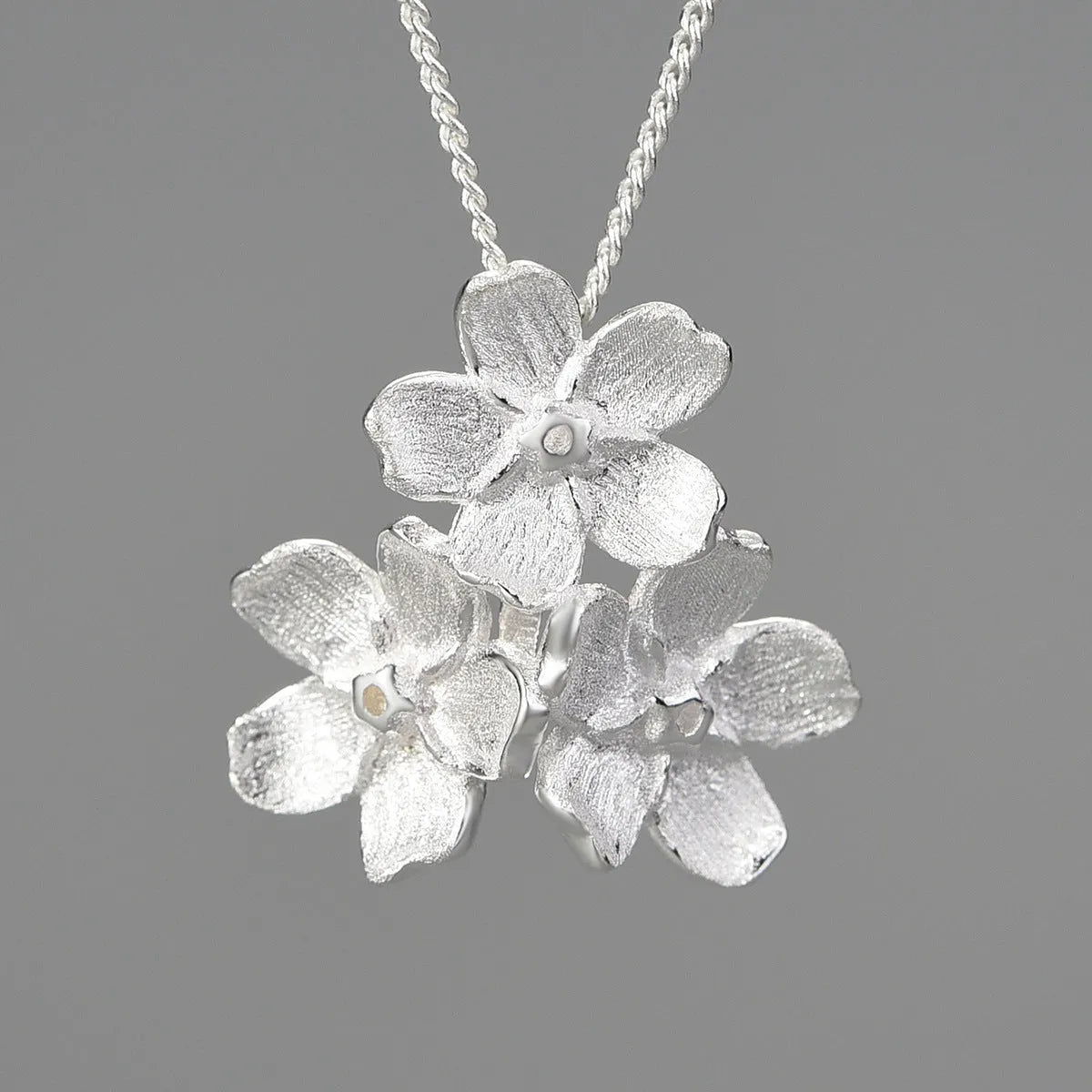 Sterling silver Myosotis sylvatica floral pendant in pastoral open mouth design without chain
