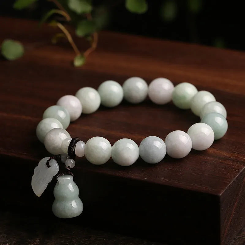 Natural jade geometric bracelet with hanging charm showing Apple design option