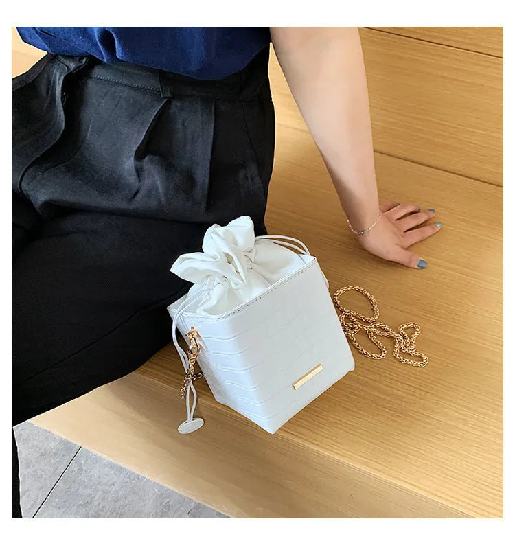 Women's small one shoulder messenger bag with chain strap in bucket style design