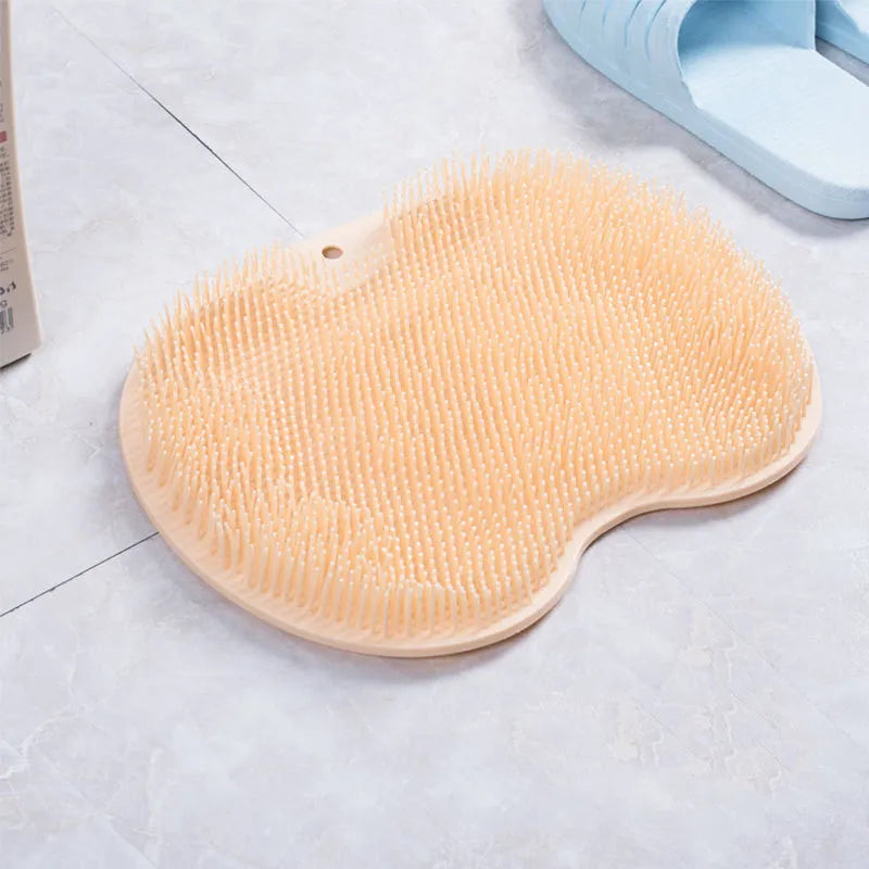 Orange silicone bristle bath brush with suction cups on base, size 23x30cm, for foot and back cleaning.