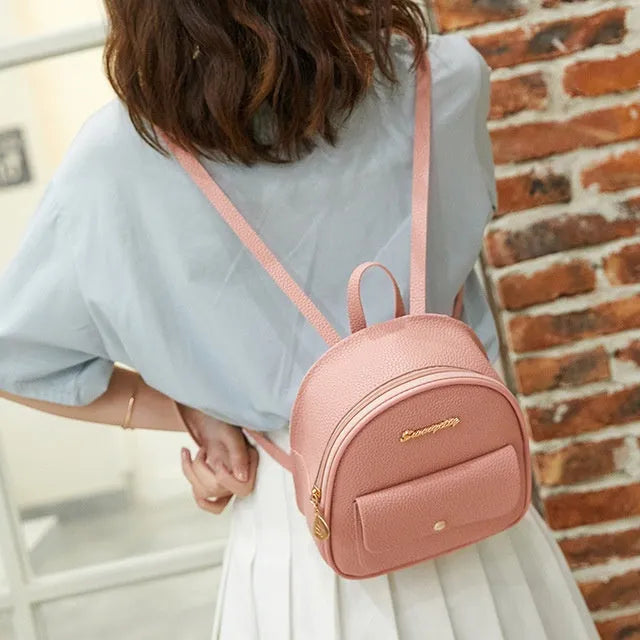 Small black PU leather women's shoulder backpack with zip, shown as a letter-style purse.