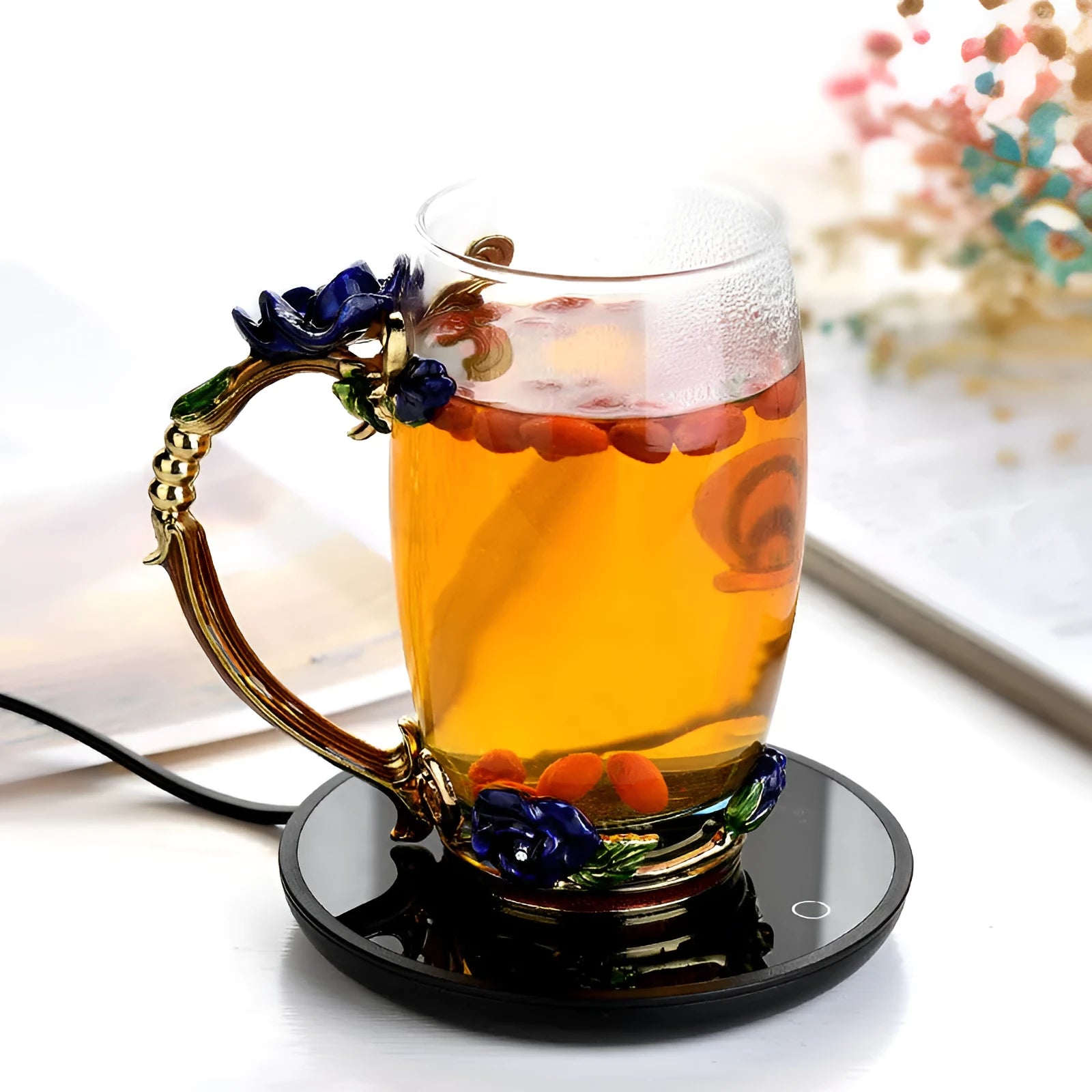 Black coffee mug warmer on a desk with low and high temperature switch