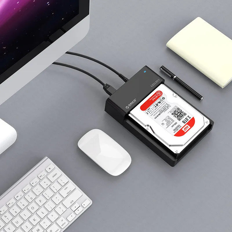 Black plastic hard disk box for 2.5-inch SATA drives with included data cable.