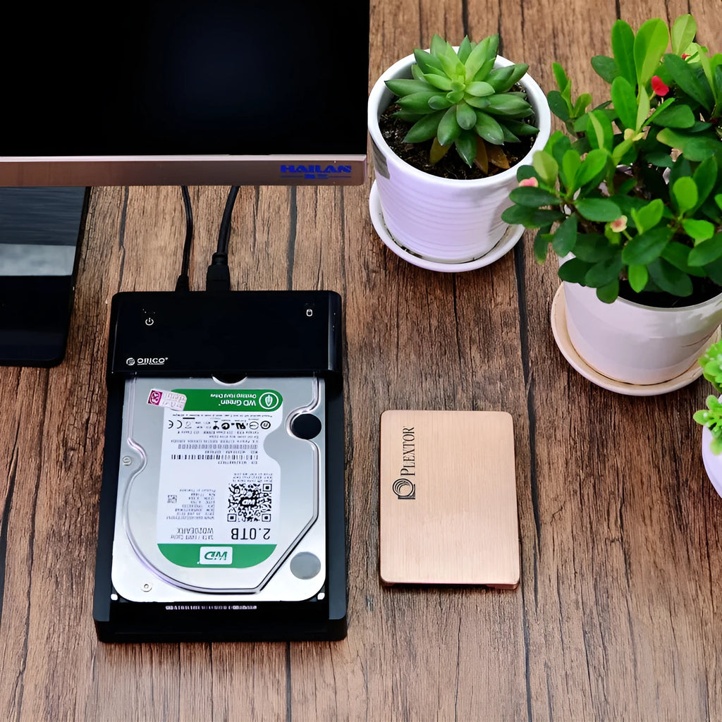 Black plastic hard disk box for 2.5-inch SATA drives with included data cable.