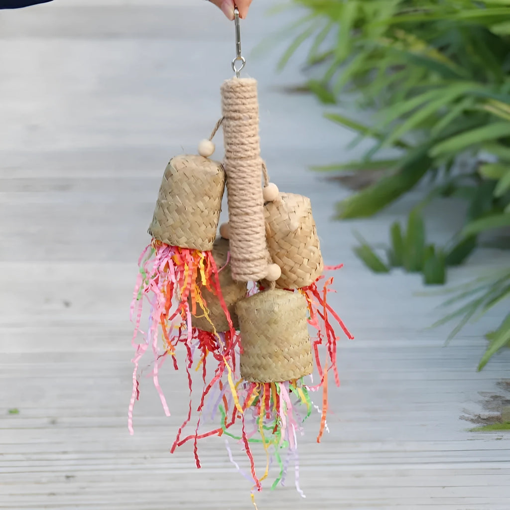 Colourful shredded paper bird toy with wood pieces and sisal fibres for parrots