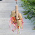 Colourful shredded paper bird toy with wood pieces and sisal fibres for parrots
