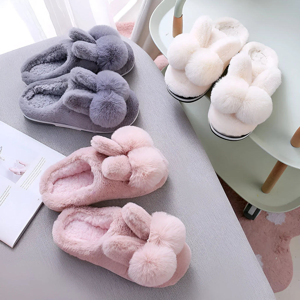 Women's fluffy bunny slippers in pink with rabbit fur, high-top sleeve design, and sewn sole.