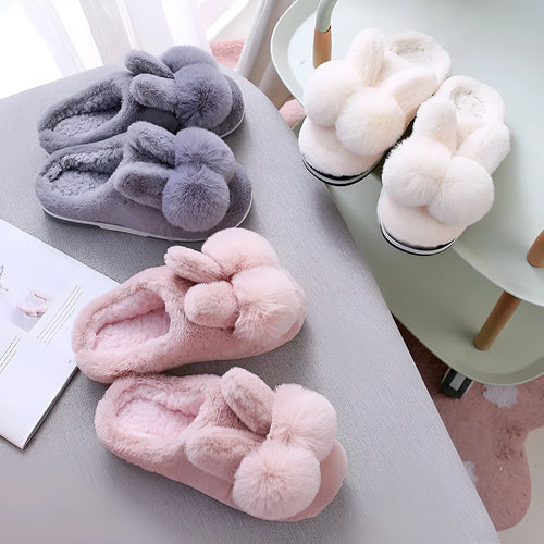 Women's fluffy bunny slippers in pink with rabbit fur, high-top sleeve design, and sewn sole.