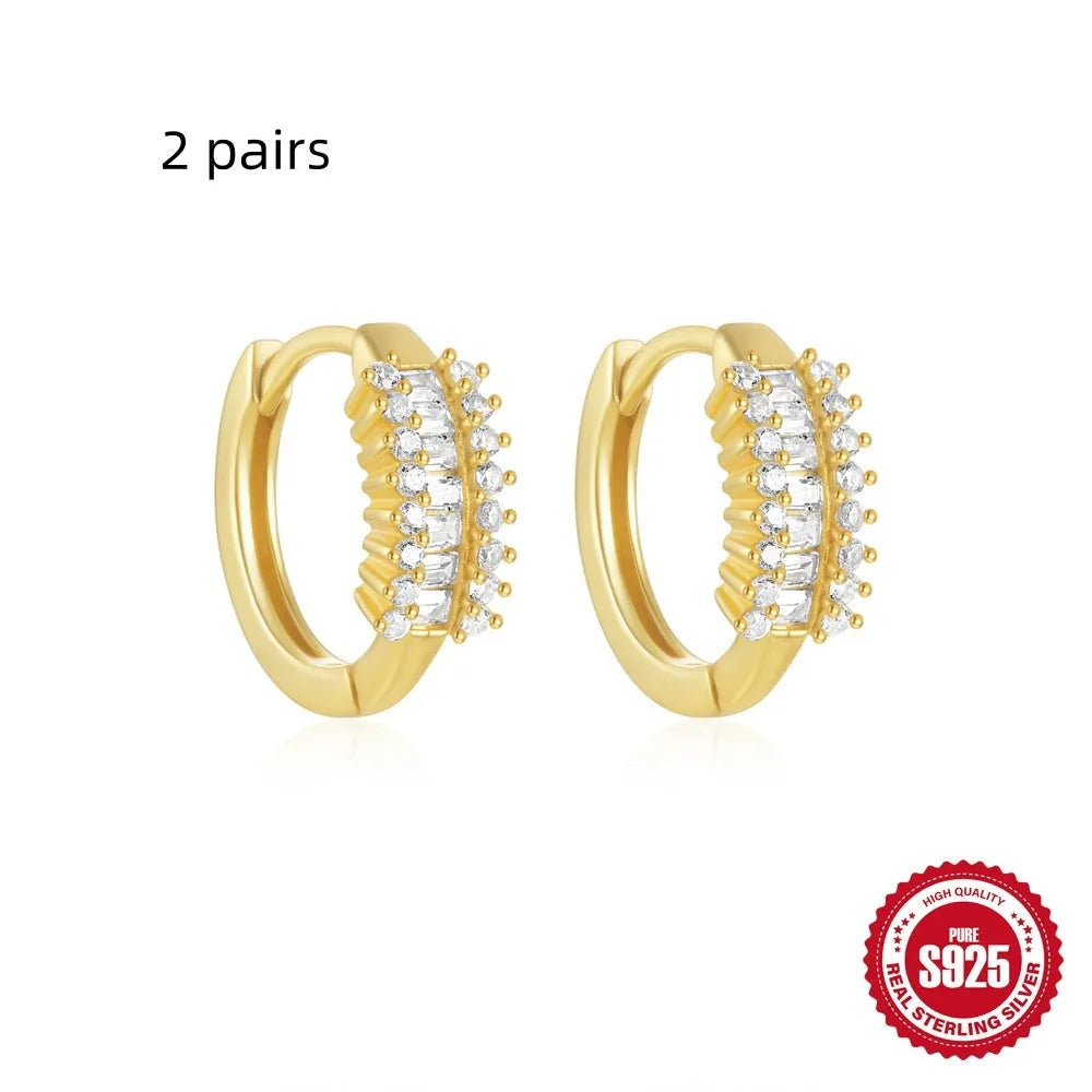 Small round geometric sterling silver stud earrings with a diamond shape, available in gold or silver finish.