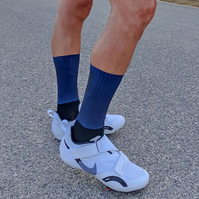 A pair of breathable athletic cycling socks in a chemical fibre blend, shown in one of six available colours.