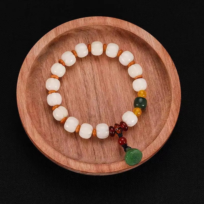 Carved pumpkin lotus bodhi root bracelet with white jade segments and golden silk jade treasures