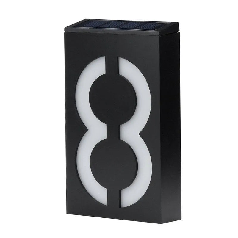 Solar-powered white LED house number light mounted on an outdoor wall
