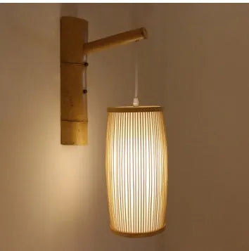 Close-up of a woven bamboo pendant light with a white E27 lamp holder, showing its natural texture and compact size.