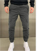 Men's loose-fit polyester casual trousers with elastic waistband and patch pockets in army green colour