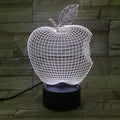 Colourful 3D fruit shaped night light with touch control on a table.