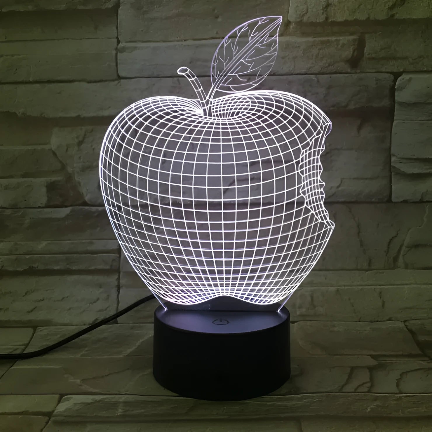 Colourful 3D fruit shaped night light with touch control on a table.